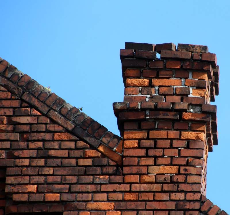Damaged chimney on an Metamora home showing cracks and missing mortar